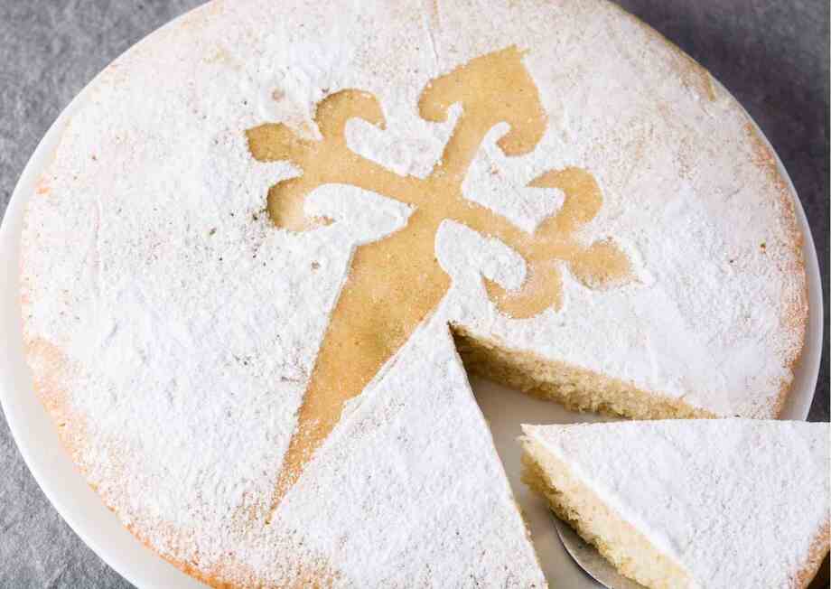 The delicious dessert "Tarta de Santiago" with the silhouette of the cross of Santiago de Compostela adorning the cake.