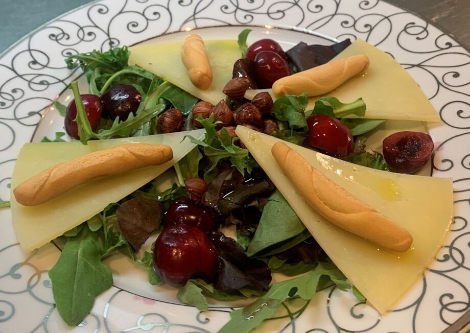 Perfect salad with Manchego cheese, cherries, break sticks, hazelnuts, etc.