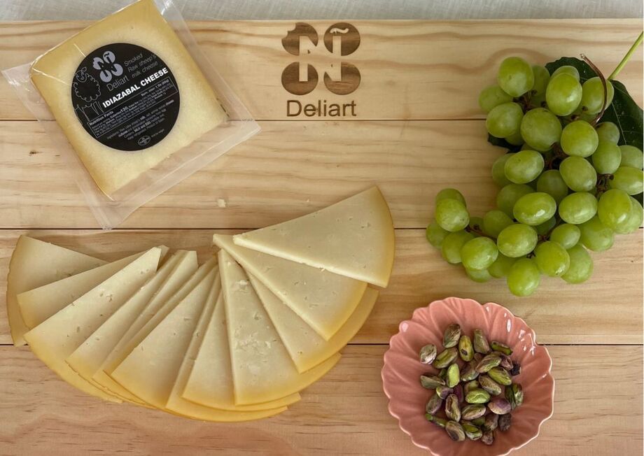 Perfect cheese board with Deliart Idiazabal cheese, grapes and pistachios.