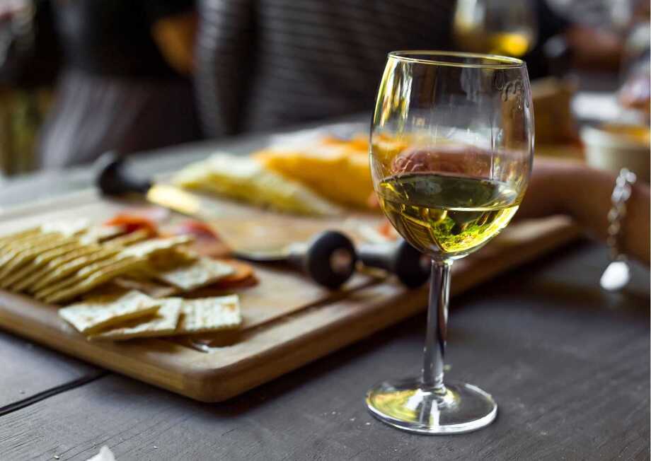The perfect pairing: an assortment of gourmet cheese accompanied by a fine glass of wine.