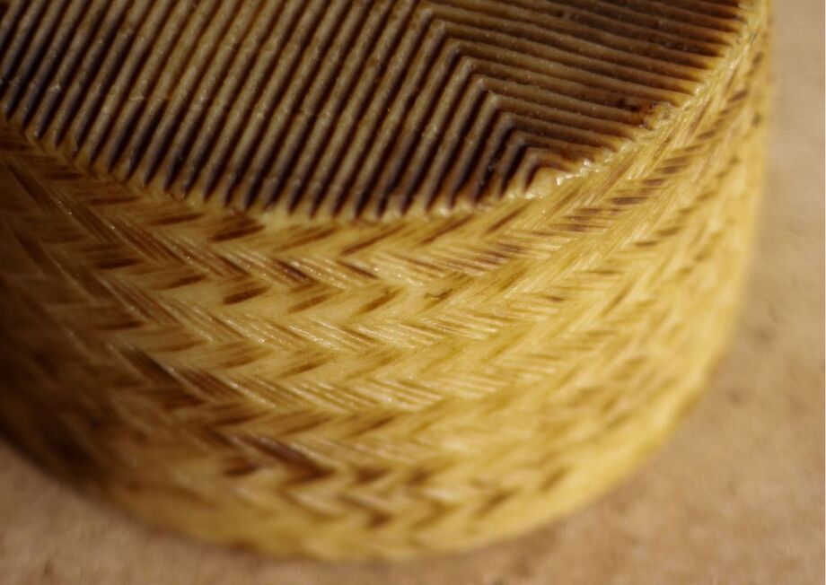 The characteristic basket weave print on Manchego cheese.