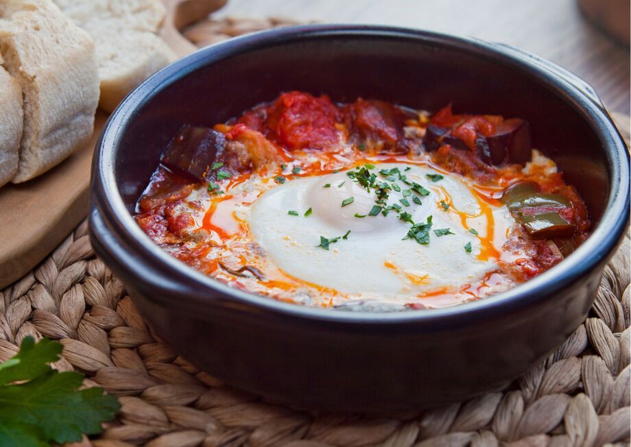 Pisto Manchego with Eggs, a Spanish culinary delight served with a touch of rustic charm.