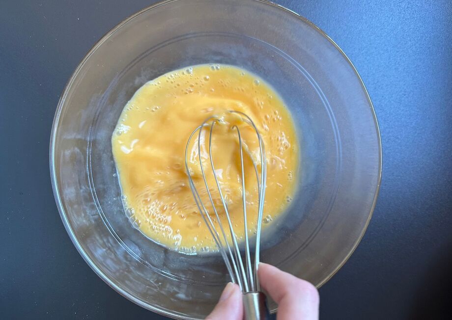 As the cheese melts, whisk the eggs simultaneously.