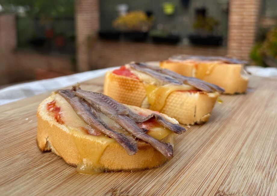 Tomato Toasts with Mahón Cheese and Anchovies are the perfect gourmet snack.