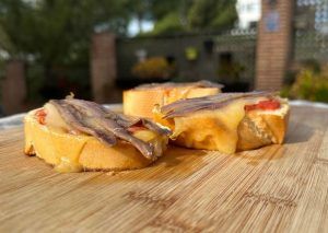 tomato toasts with mahon cheese and anchovies
