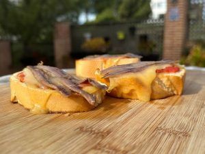 tomato toasts with mahon cheese and anchovies