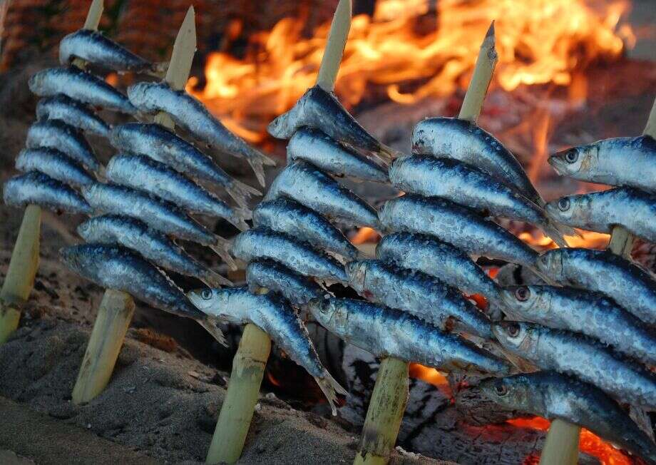 Espeto sardines grilling at a chiringuito.