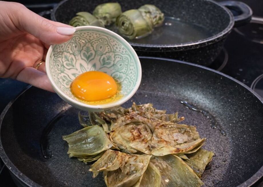 Carefully add the egg yolk on top.